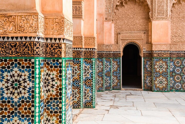 Traditional Moroccan doorway with intricate mosaic tiles and a carved wooden door