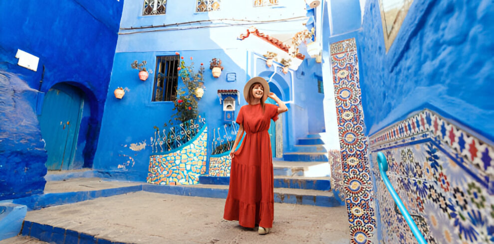 Narrow blue-painted street in Chefchaouen, Morocco, with local artisan shops