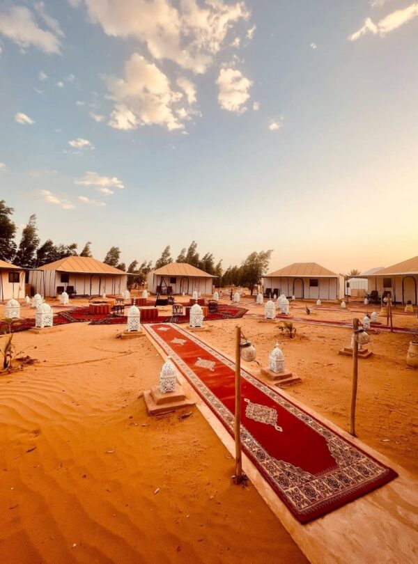 Luxury Sahara desert camp in Merzouga with traditional tents and lanterns in Erg Chebbi dunes
