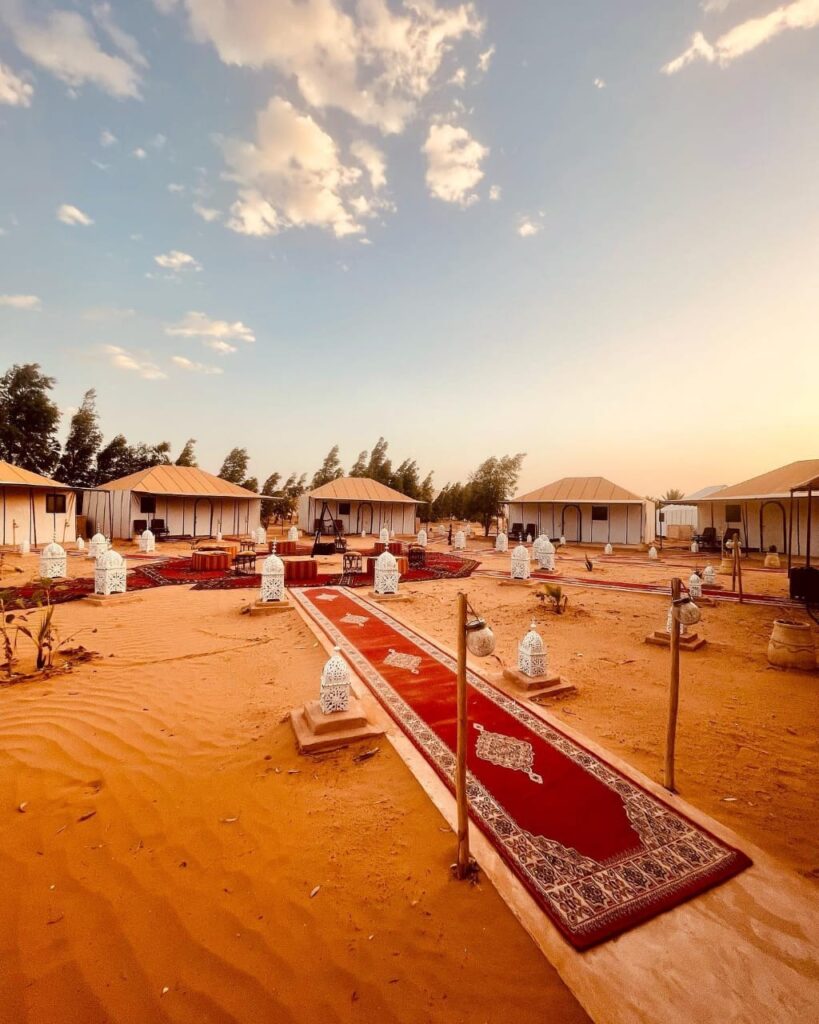 Luxury Sahara desert camp in Merzouga with traditional tents and lanterns in Erg Chebbi dunes